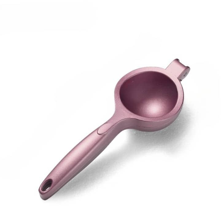 Presse citron design rose gold à bras et coupelle vu de dessus sur fond blanc, poignée allongée